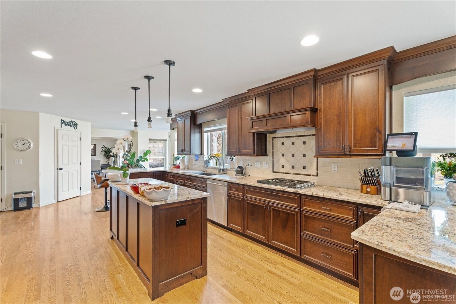 1918 Broadview Wenatchee, WA 98801 - Photo 12 of 38 a kitchen with stainless steel appliances granite countertop a stove a sink dishwasher and a refrigerator with wooden floor