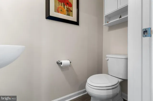 a white toilet sitting next to a white walls