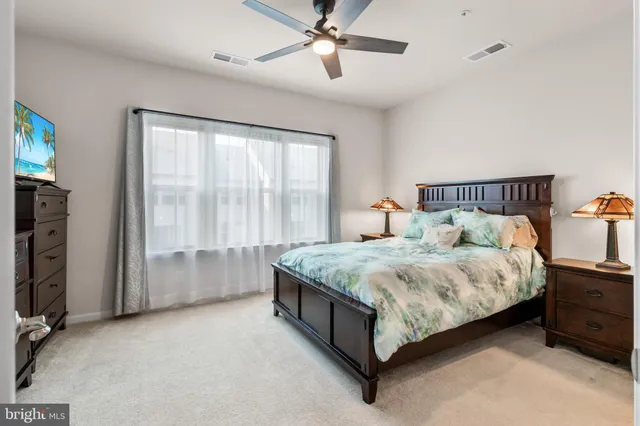 a bed sitting in a room next to a window