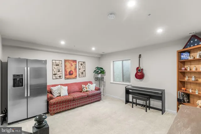 a view of a livingroom with furniture and staircase