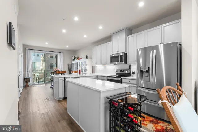 a kitchen with granite countertop a sink appliances and cabinets