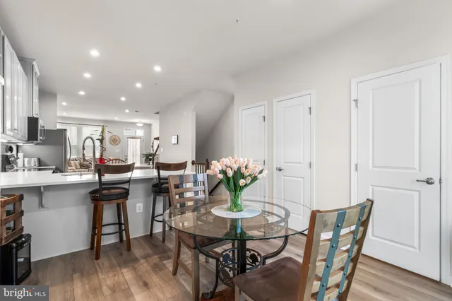 a dining room with furniture and wooden floor