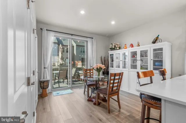a dining room with furniture and wooden floor