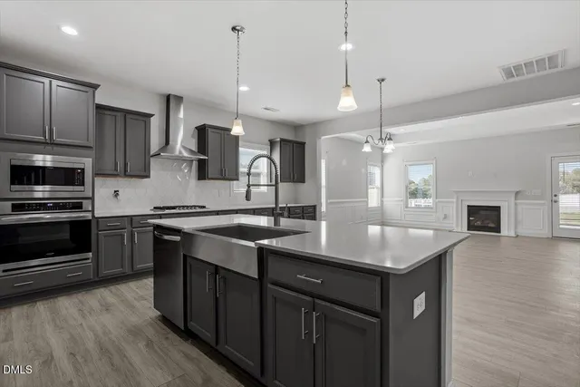 a kitchen with a sink a microwave a stove and refrigerator