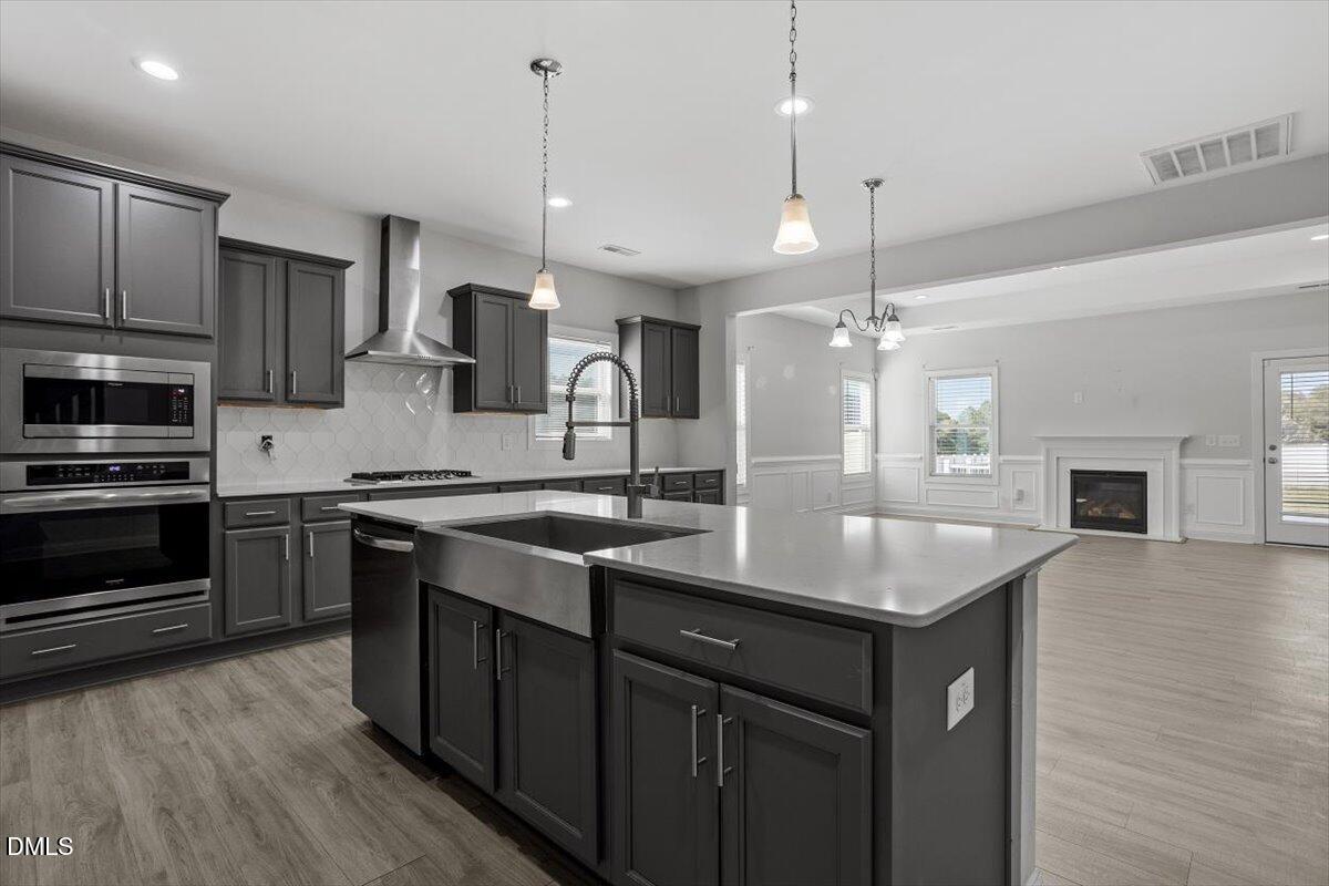 114 Stephens Timberline View Clayton, NC 27520 - Photo 20 of 43 a kitchen with a sink a microwave a stove and refrigerator