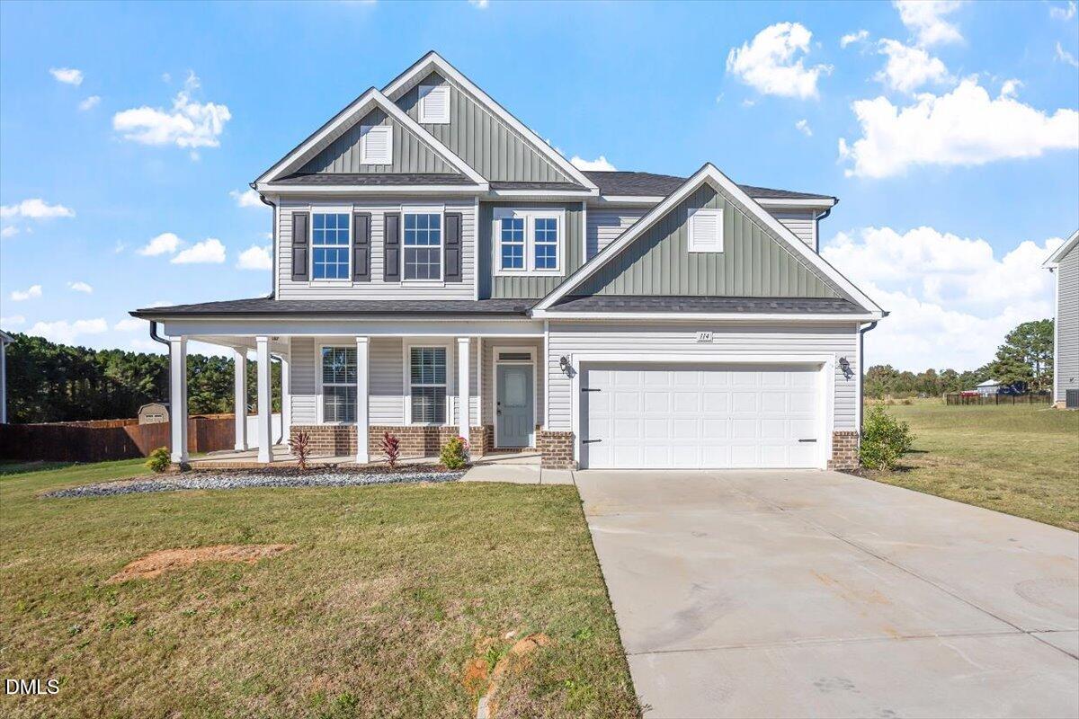 114 Stephens Timberline View Clayton, NC 27520 - Photo 2 of 43 a front view of a house with a yard and garage
