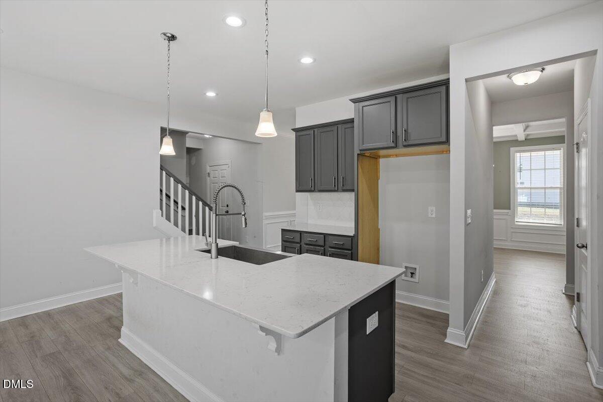 114 Stephens Timberline View Clayton, NC 27520 - Photo 23 of 43 a kitchen with a sink a refrigerator and wooden floor