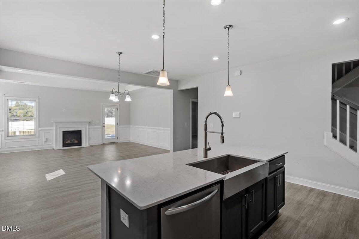 114 Stephens Timberline View Clayton, NC 27520 - Photo 25 of 43 a kitchen with kitchen island a sink appliances and a wooden floor