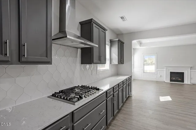 a kitchen with stainless steel appliances a stove a sink and a refrigerator