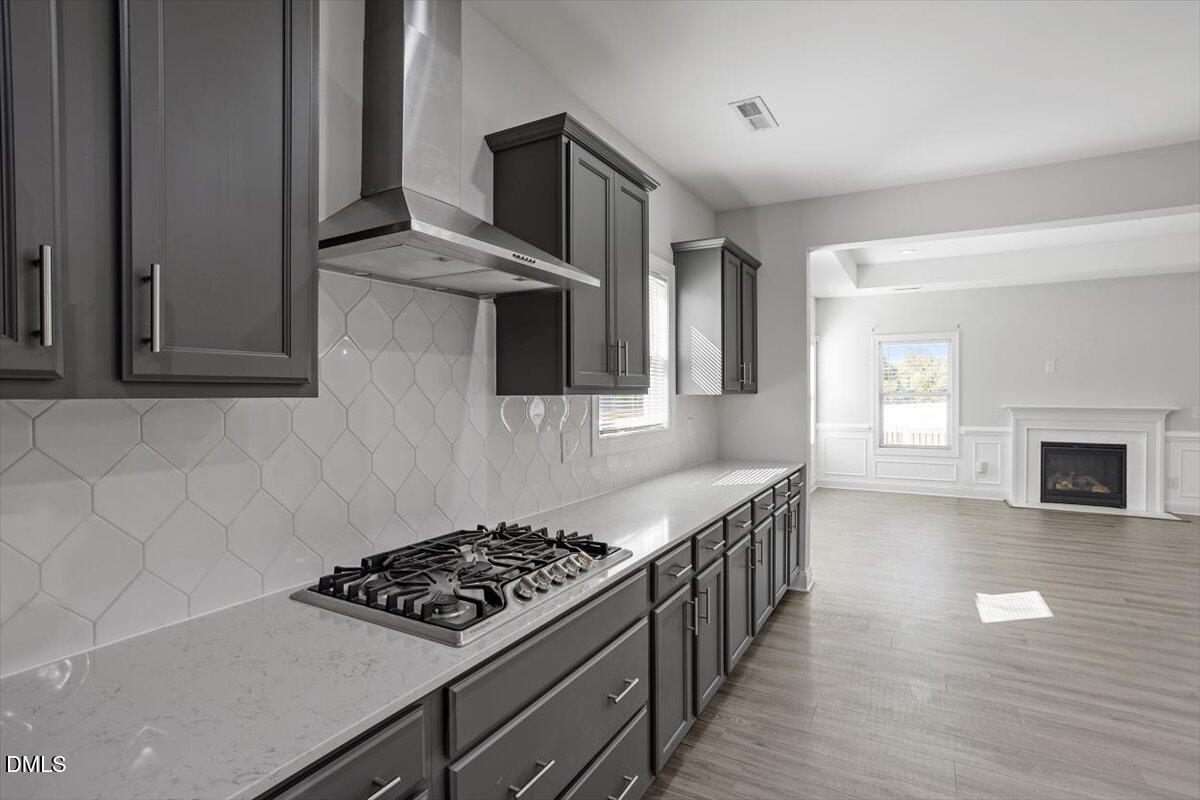 114 Stephens Timberline View Clayton, NC 27520 - Photo 26 of 43 a kitchen with stainless steel appliances a stove a sink and a refrigerator