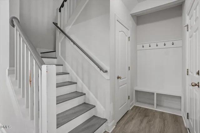 a view of a hallway with wooden floor and entryway