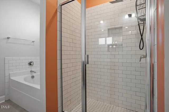 a bathroom with a bathtub and shower