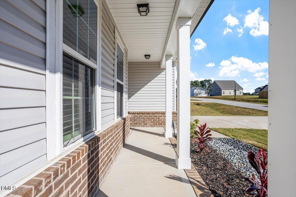 114 Stephens Timberline View Clayton, NC 27520 - Photo 5 of 43 a view of a balcony with floor to ceiling windows with wooden floor