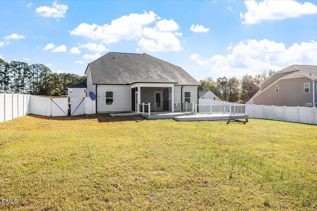 a house view with swimming pool in front of it