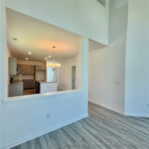 a large room with kitchen view and a sink