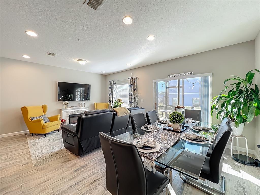 381 Smugglers Way Apopka, FL 32712 - Photo 12 of 53 a living room with furniture a flat screen tv and a large window