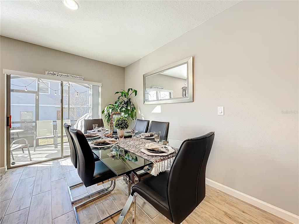 381 Smugglers Way Apopka, FL 32712 - Photo 13 of 53 a view of a dining room with furniture window and wooden floor