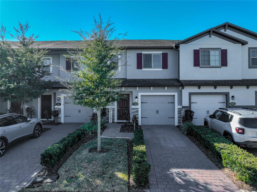 381 Smugglers Way Apopka, FL 32712 - Photo 2 of 53 a front view of a house with a yard and garage