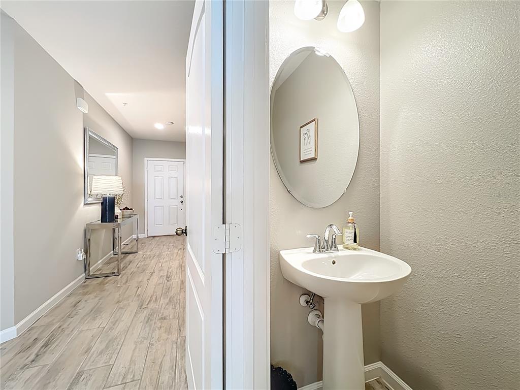 381 Smugglers Way Apopka, FL 32712 - Photo 21 of 53 a en suite bathroom with a sink and a mirror