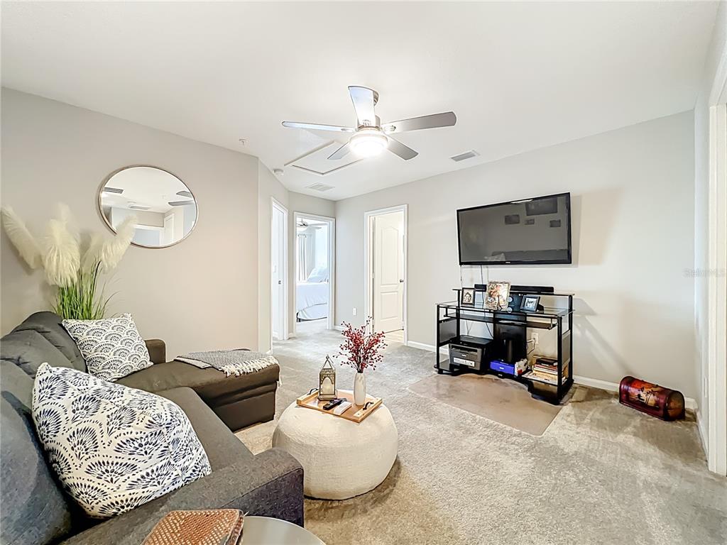 381 Smugglers Way Apopka, FL 32712 - Photo 25 of 53 a living room with furniture and a flat screen tv