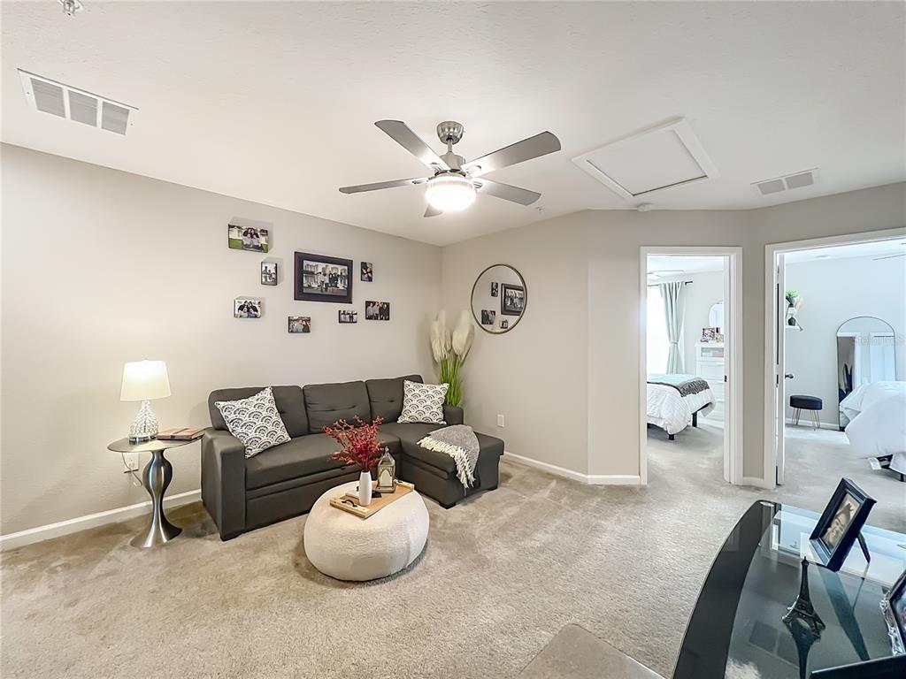 381 Smugglers Way Apopka, FL 32712 - Photo 26 of 53 a living room with furniture and a chandelier