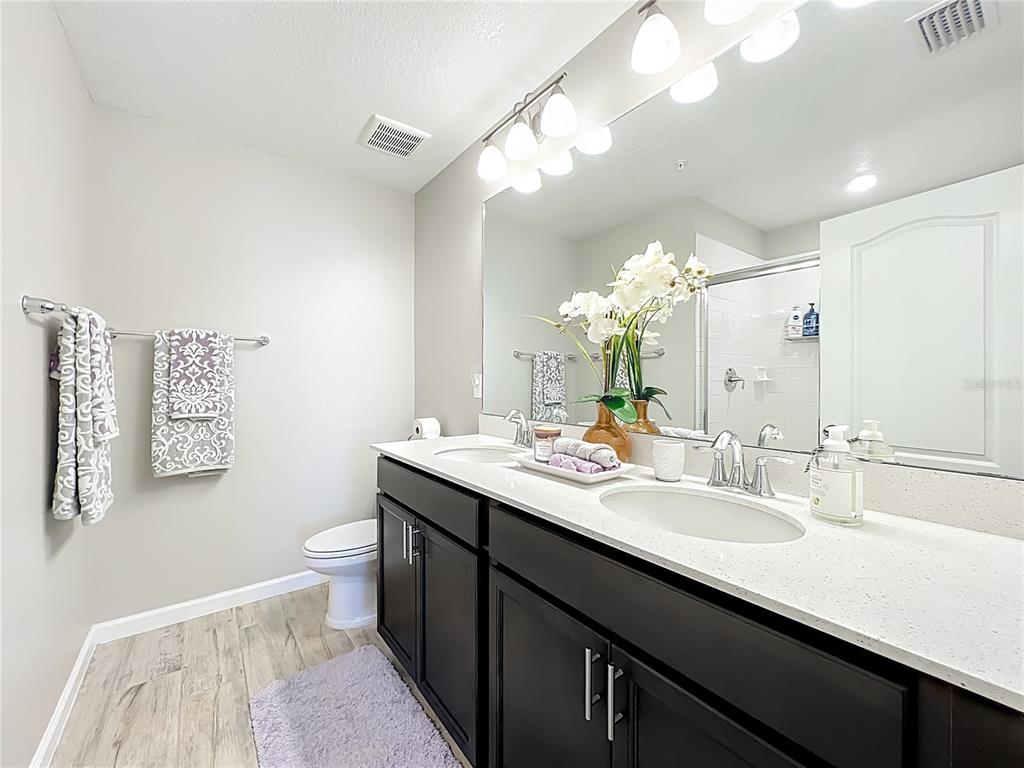 381 Smugglers Way Apopka, FL 32712 - Photo 32 of 53 a bathroom with a sink a toilet and a mirror