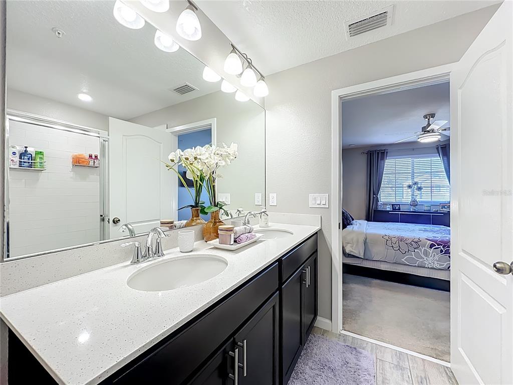 381 Smugglers Way Apopka, FL 32712 - Photo 34 of 53 a en suite bathroom with double vanity and a mirror