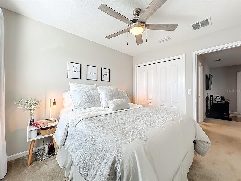 381 Smugglers Way Apopka, FL 32712 - Photo 36 of 53 a bedroom with a large bed and a chandelier