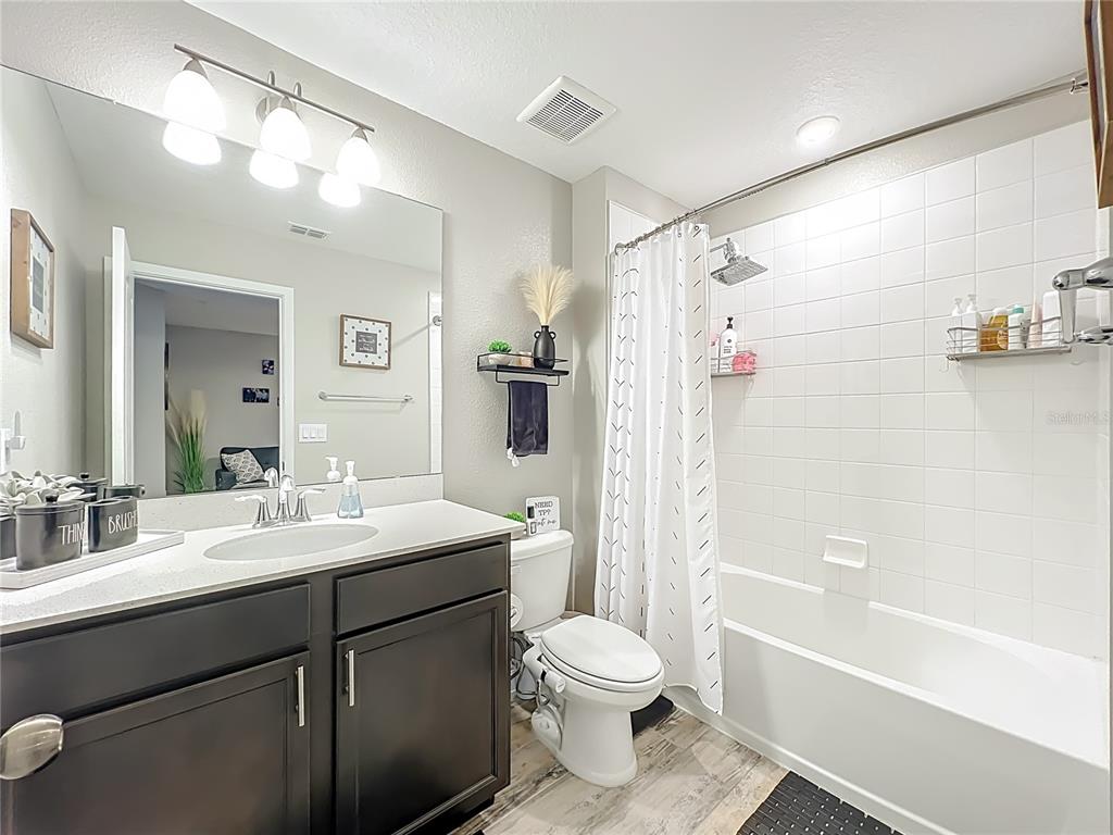 381 Smugglers Way Apopka, FL 32712 - Photo 37 of 53 a bathroom with a sink a toilet and shower