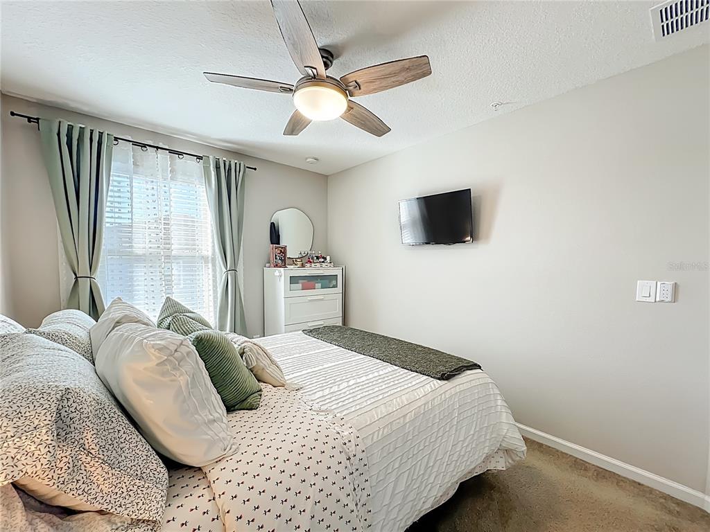 381 Smugglers Way Apopka, FL 32712 - Photo 38 of 53 a bedroom with a bed and a flat screen tv