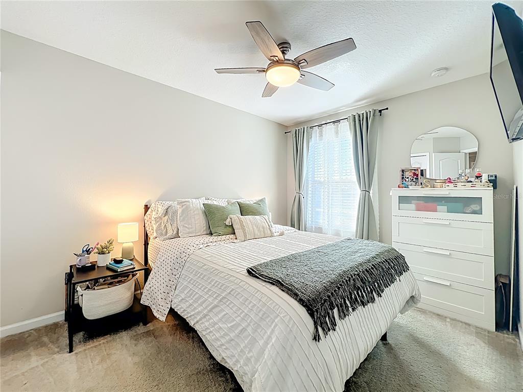 381 Smugglers Way Apopka, FL 32712 - Photo 39 of 53 a bedroom with a bed and a chandelier