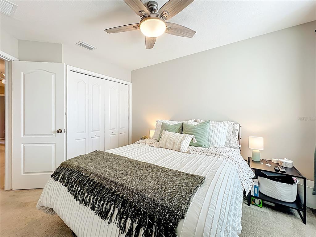 381 Smugglers Way Apopka, FL 32712 - Photo 40 of 53 a bedroom with a bed and ceiling fan