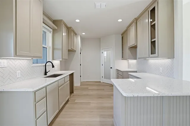 a kitchen with a sink cabinets and appliances