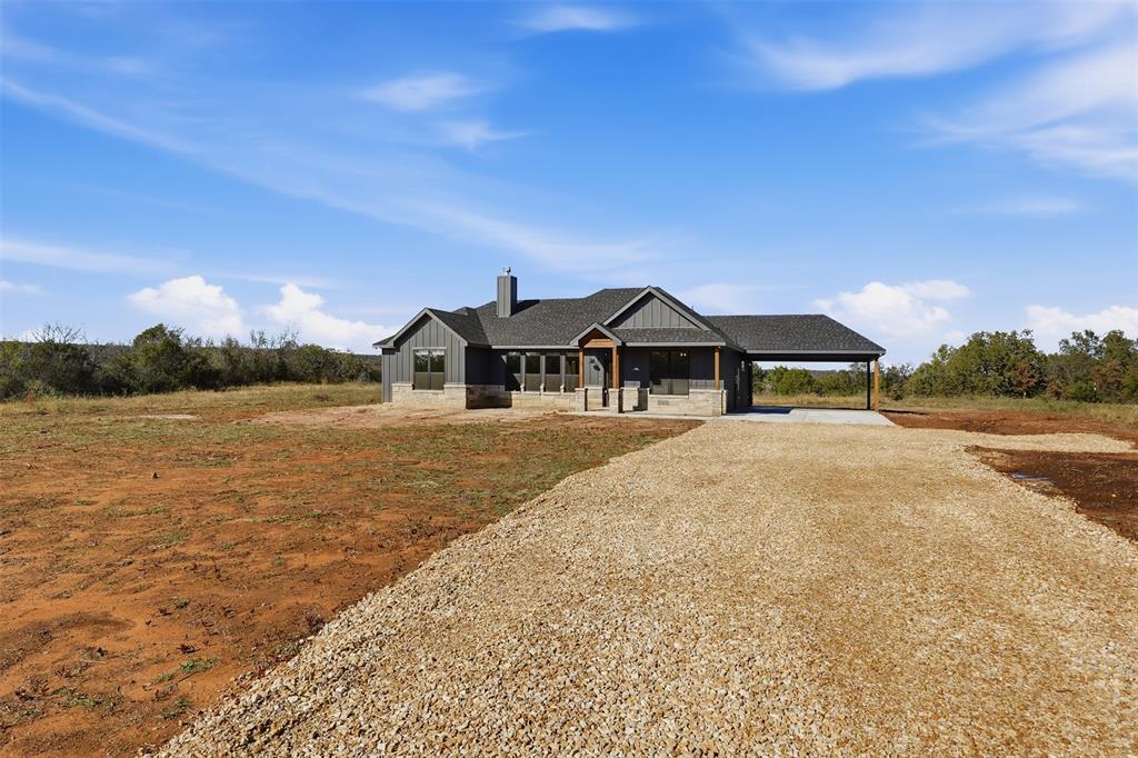 1865 Dobbs Valley Road Mineral Wells, TX 76067 - Photo 2 of 37 a front view of a house with a yard