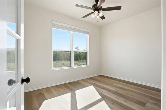 an empty room with fan and a ceiling fan