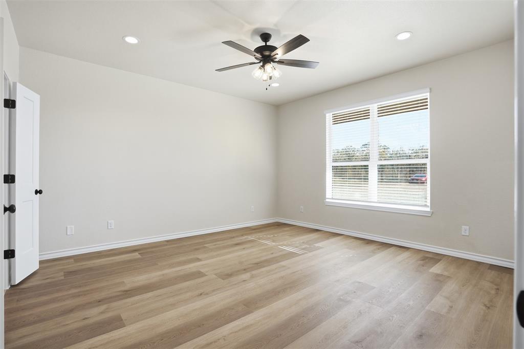 1865 Dobbs Valley Road Mineral Wells, TX 76067 - Photo 22 of 37 wooden floor in an empty room with a window