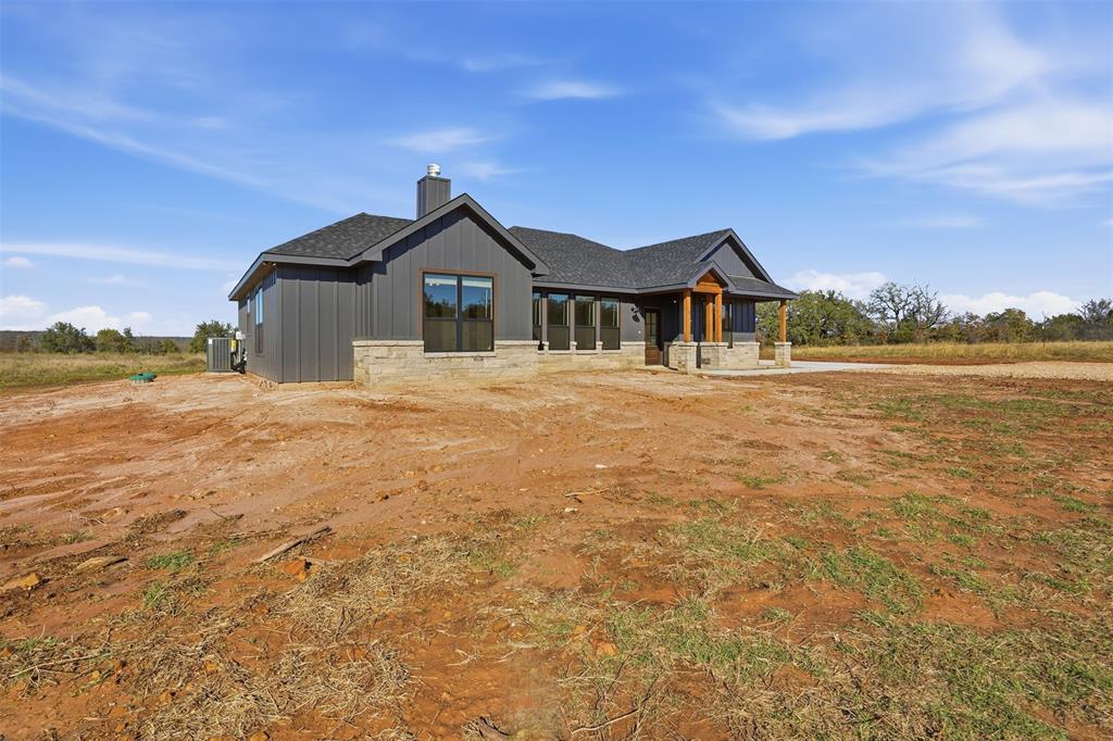 1865 Dobbs Valley Road Mineral Wells, TX 76067 - Photo 3 of 37 a front view of a house with a yard