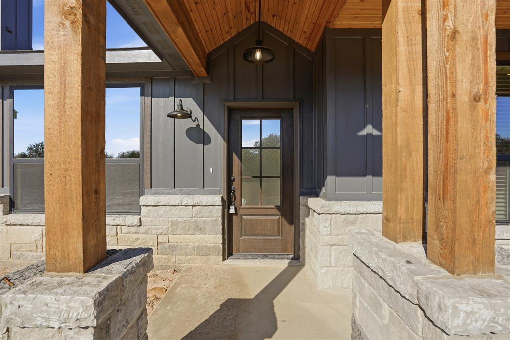 1865 Dobbs Valley Road Mineral Wells, TX 76067 - Photo 6 of 37 a living room with a couch and a stove with wooden floor