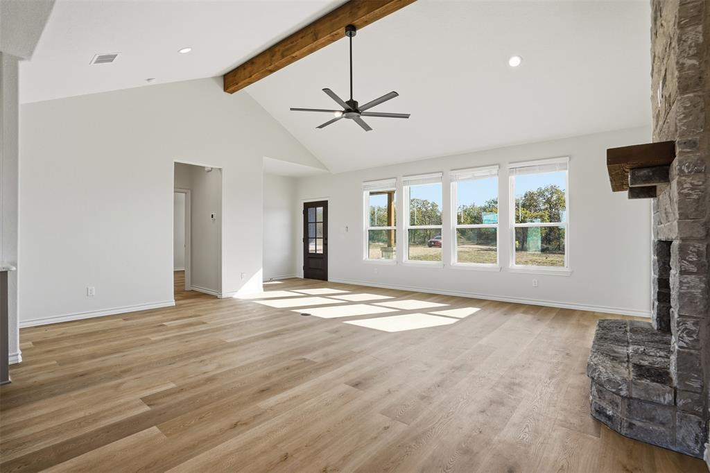 1865 Dobbs Valley Road Mineral Wells, TX 76067 - Photo 10 of 37 a view of an empty room with a window and wooden floor