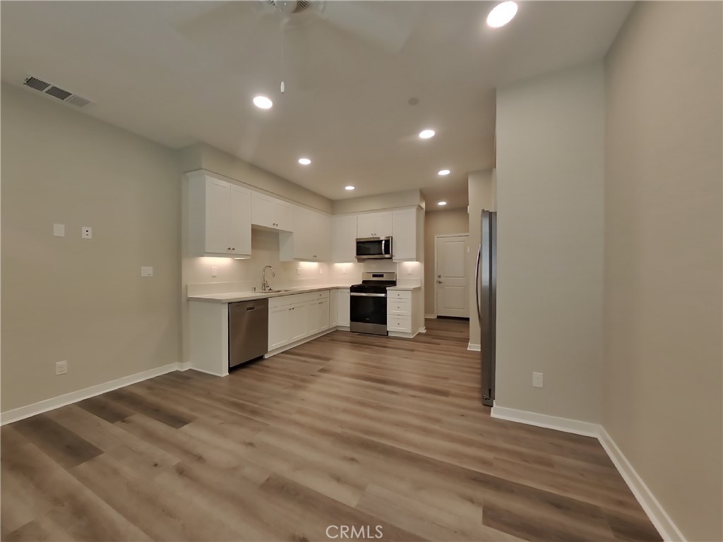 24970 Vermijo Court Wildomar, CA 92595 - Photo 3 of 28 a view of a kitchen with a sink and microwave