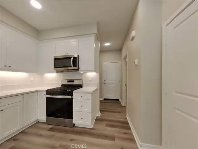 a kitchen with a sink and stainless steel appliances