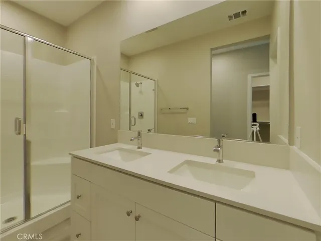 a bathroom with a shower sink and mirror