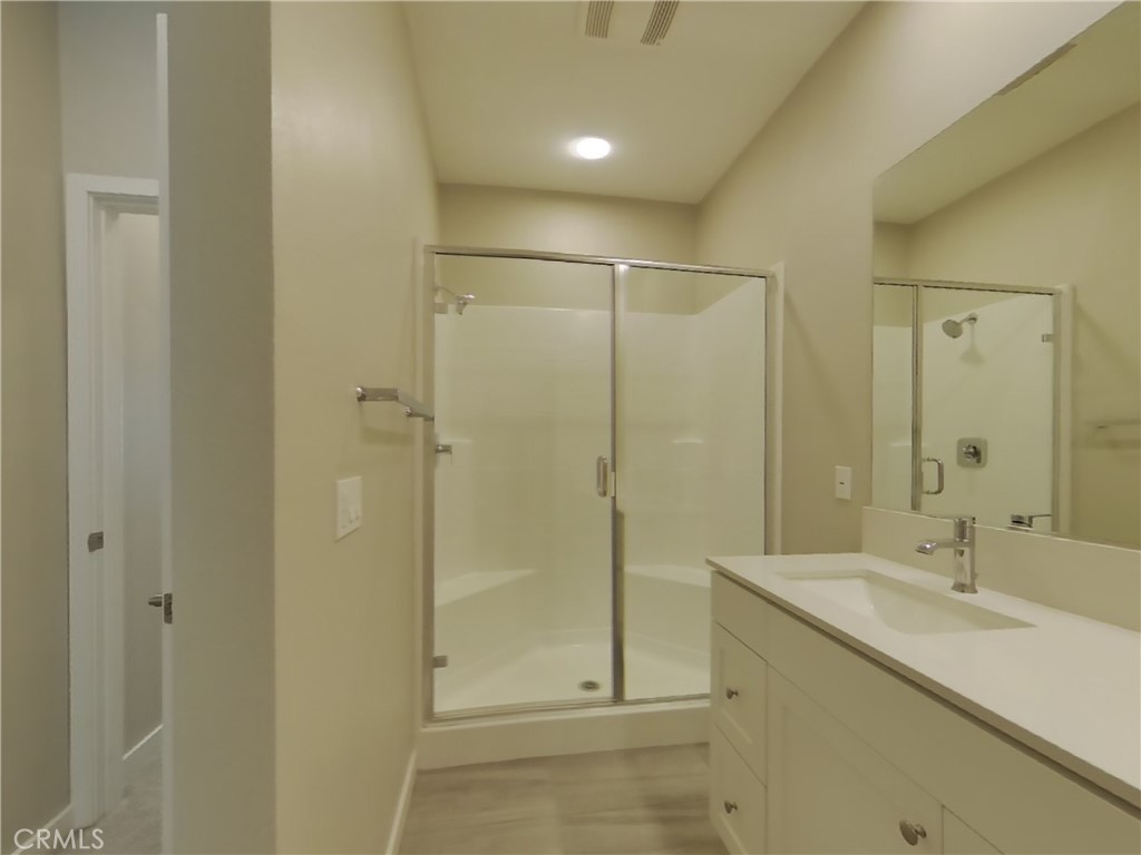 24970 Vermijo Court Wildomar, CA 92595 - Photo 8 of 28 a bathroom with a shower sink and mirror