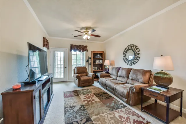 a view of a balcony with wooden floor and a glass door