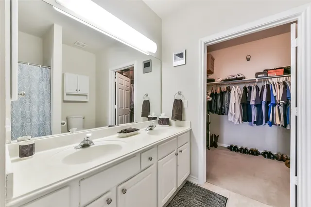 a en suite bathroom with a double vanity sink mirror and double