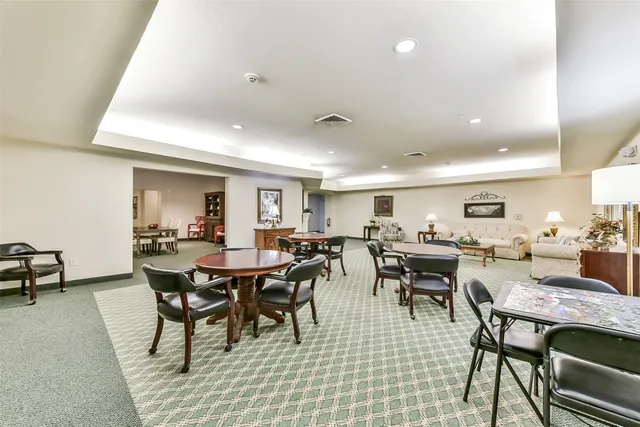 a living room with furniture a rug and a table