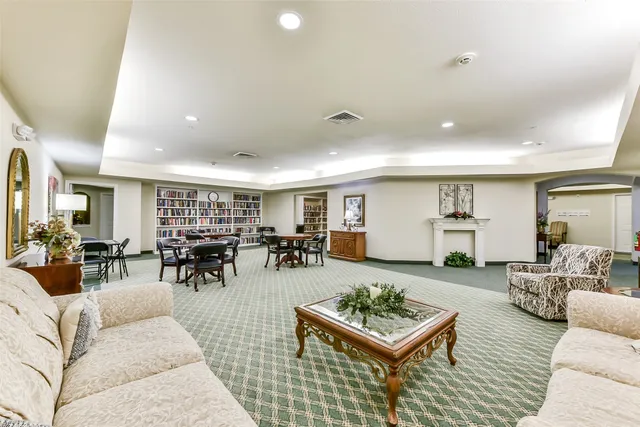 a living room with furniture and view of kitchen