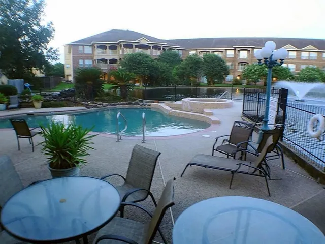 a view of a chairs and table in patio with a lake view