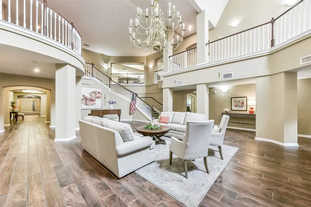 a living room with furniture and a chandelier