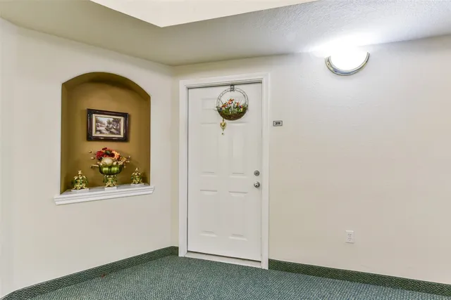 a view of a hallway with front door